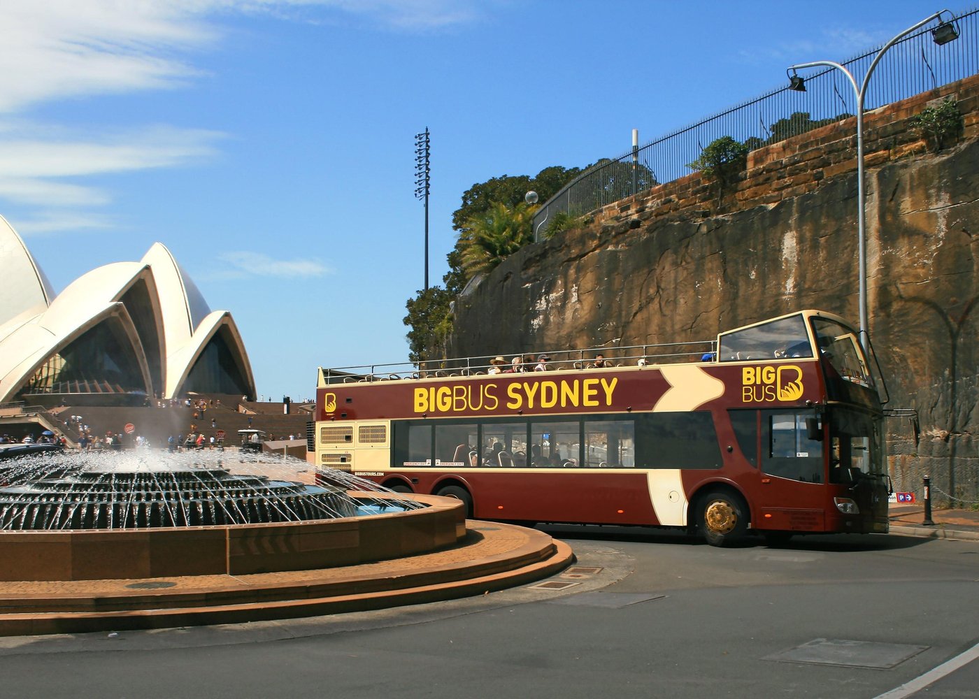 Big Bus Tours in Sydney passing by the Sydney Opera House with panoramic views of the city skyline