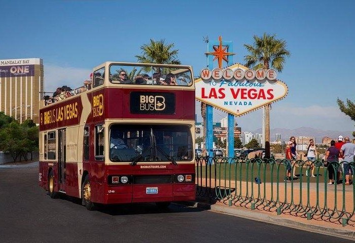 Big Bus Tours in Las Vegas cruising down the Strip with views of famous casinos, neon lights, and iconic landmarks like the Bellagio and Eiffel Tower