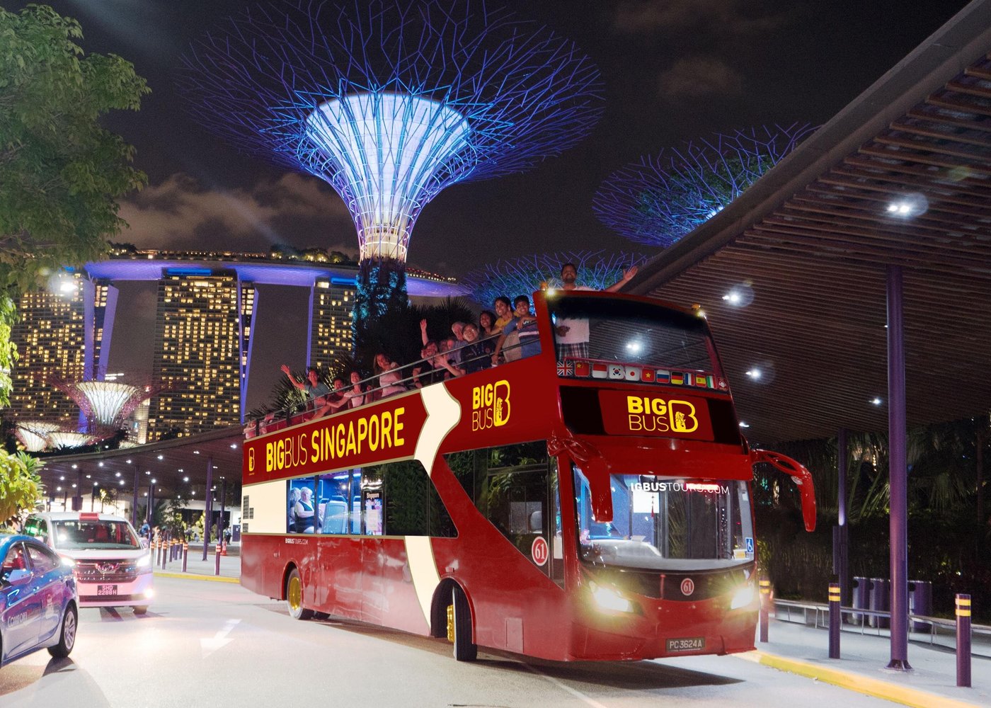 Big Bus Tours in Singapore passing iconic landmarks like Marina Bay Sands and Gardens by the Bay with open-top city views