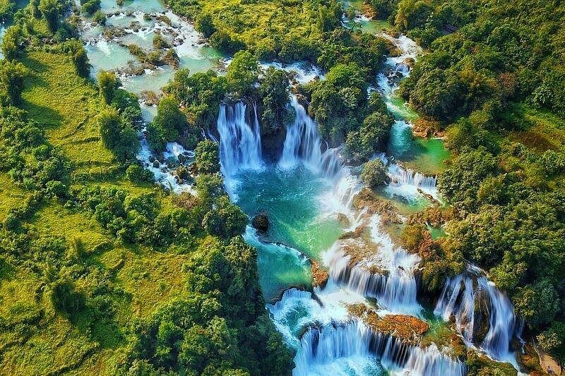 A peaceful mountain lake and Ban Gioc Water Fall Best of North for kayaking and cave tours.