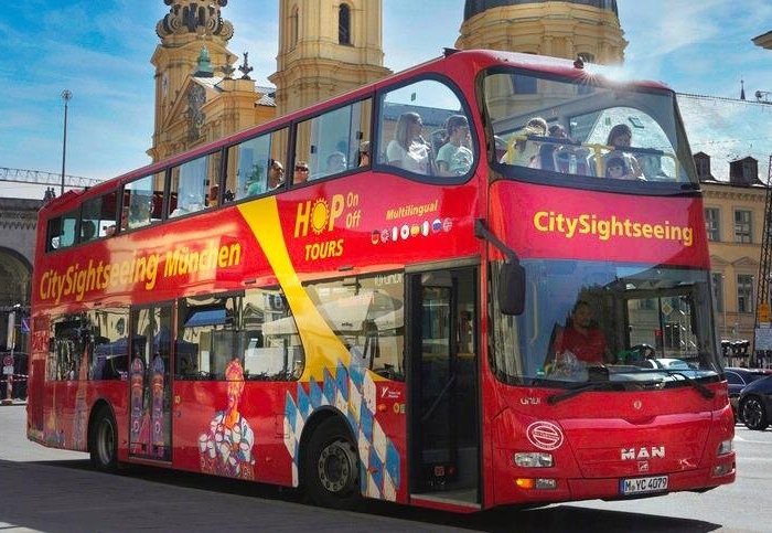 Big Bus Tours in Munich passing Marienplatz with views of the Glockenspiel, historic churches, and Bavarian architecture