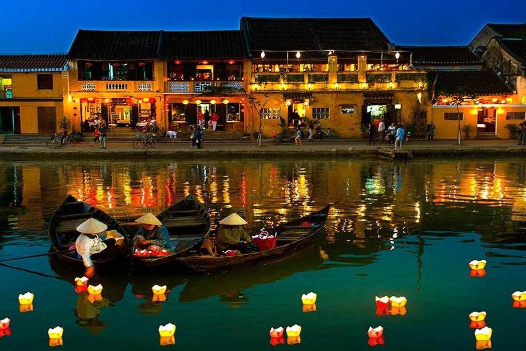 A lantern-lit riverside town famous for its preserved architecture, tailors, and night markets. Visit during the Full Moon Lantern Festival