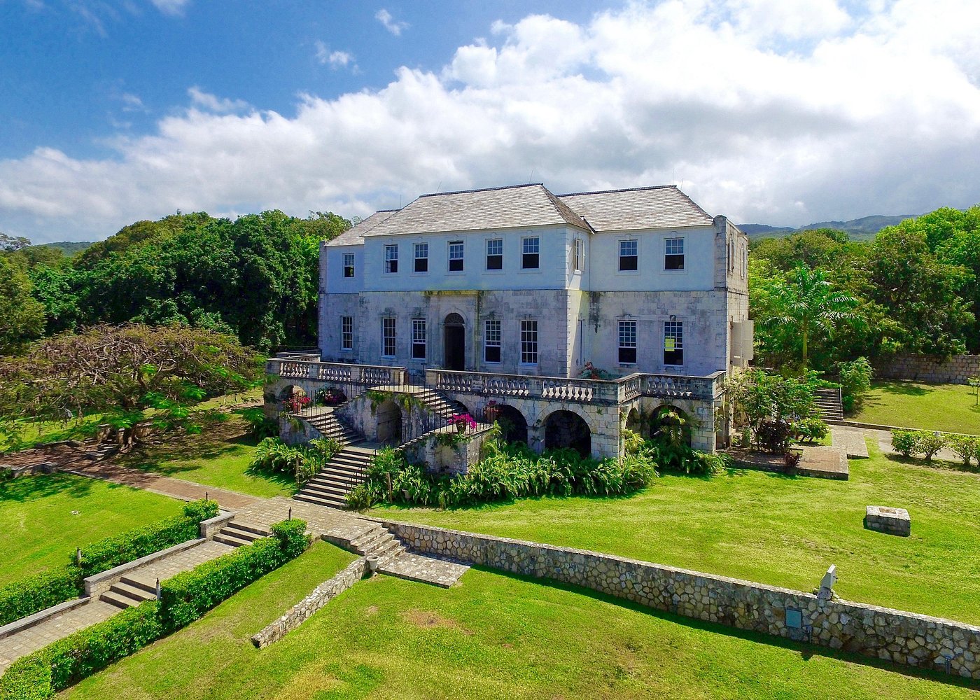 image of the Rose Hall plantation house surrounded by blue skies and pretty gardens