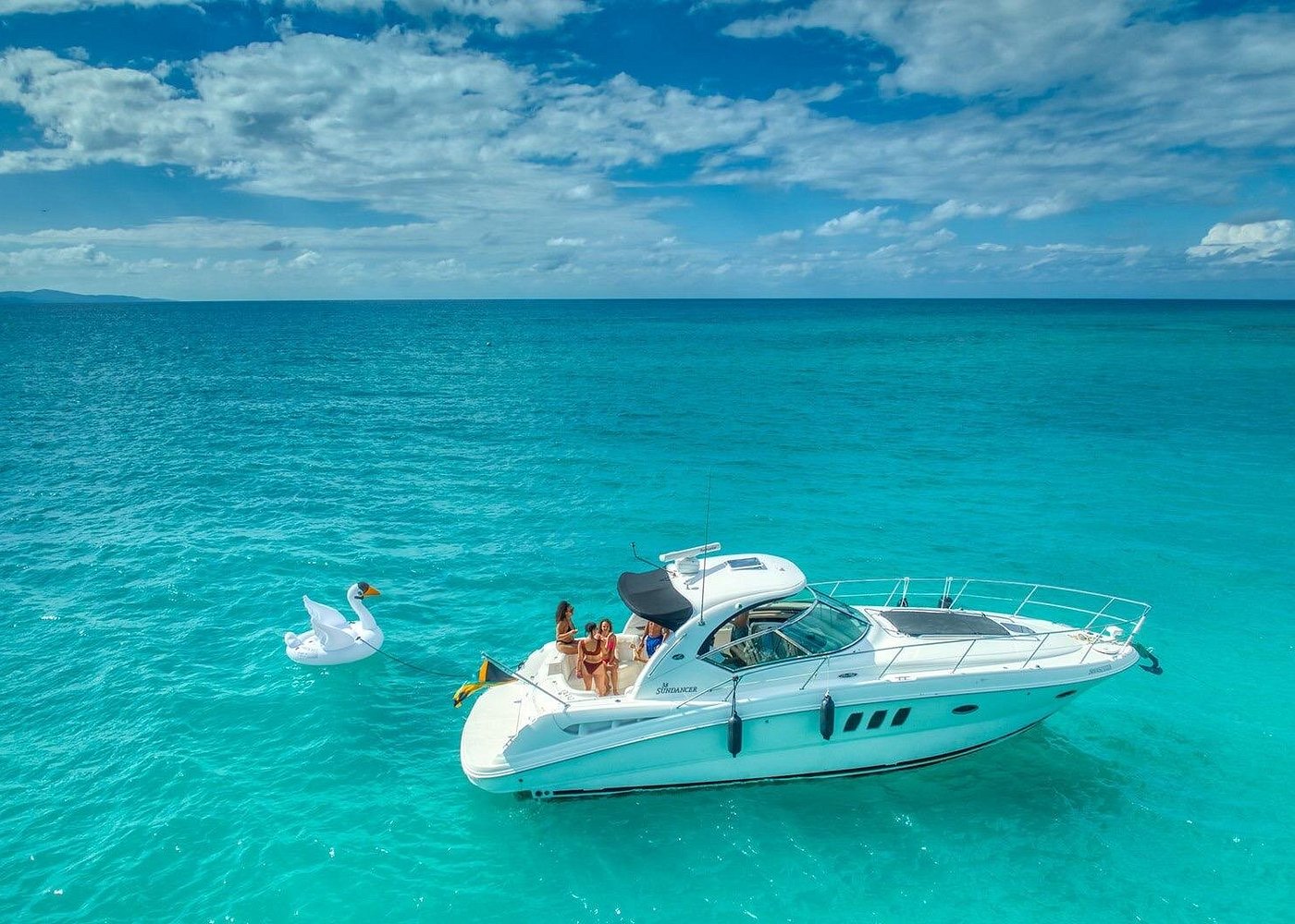 a private yacht floating on crystal clear blue water as a relaxing tour in Jamaica