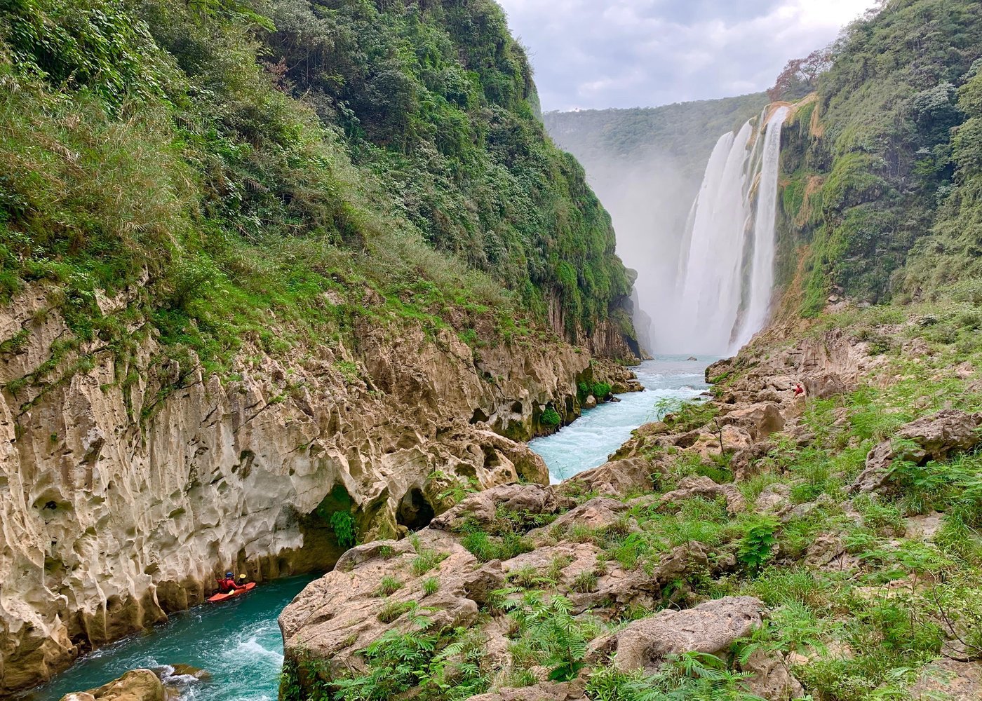 Tamul waterfall and water cave on a wooden canoe

