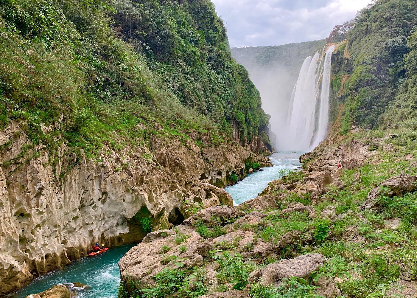 Tamul waterfall and water cave on a wooden canoe