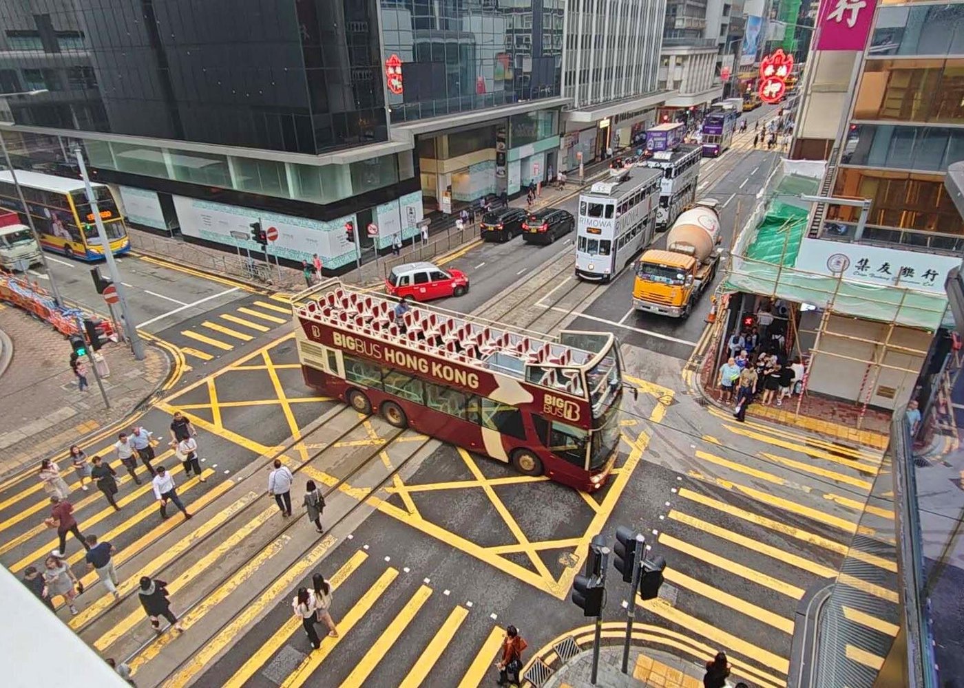 Big Bus Tours in Hong Kong cruising through Central District with views of Victoria Harbour and towering skyscrapers