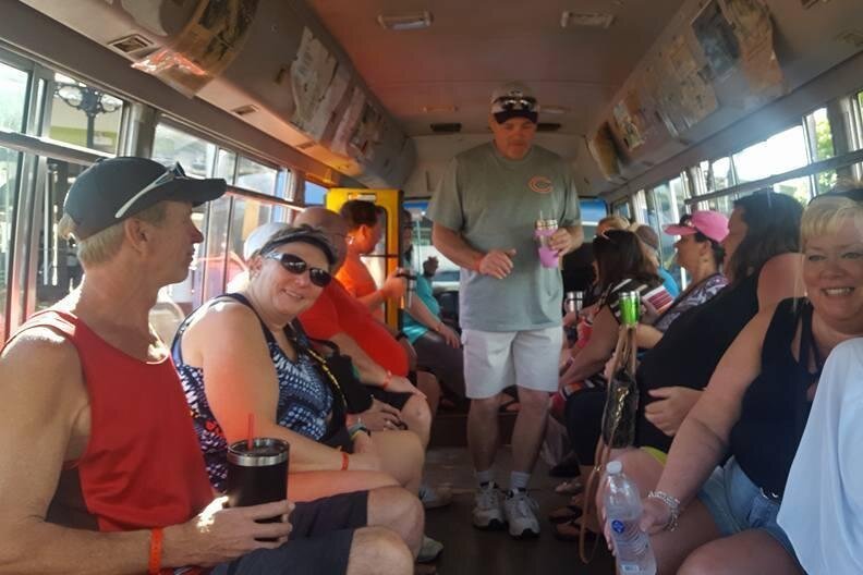 people sitting on a bus tour in jamaica taking them to multiple local bars in Negril 