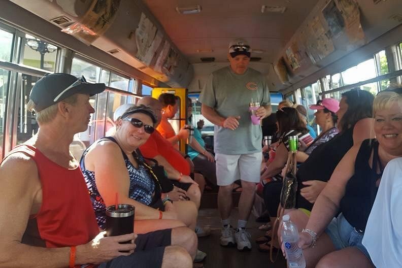 people sitting on a bus tour in jamaica taking them to multiple local bars in Negril