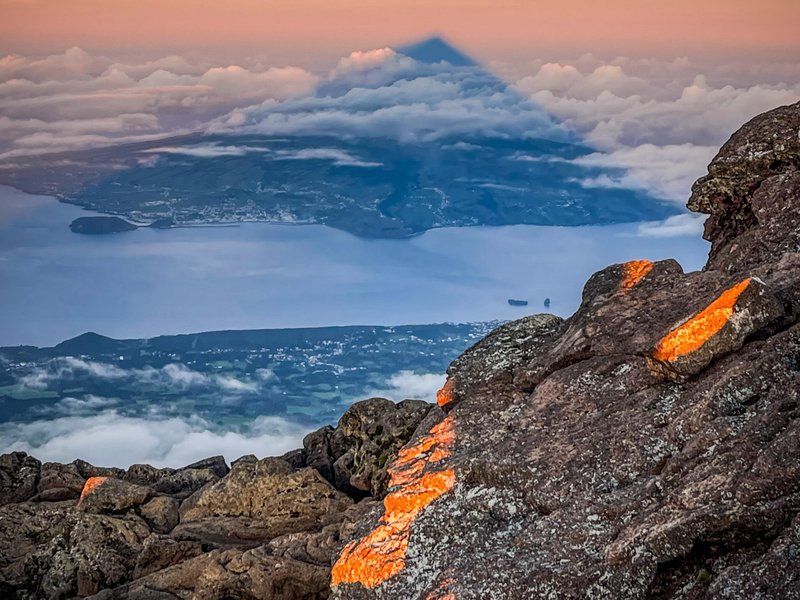 The shadow of Mount Pico painted on the morning sky — a night climb that ends in pure wonder.
