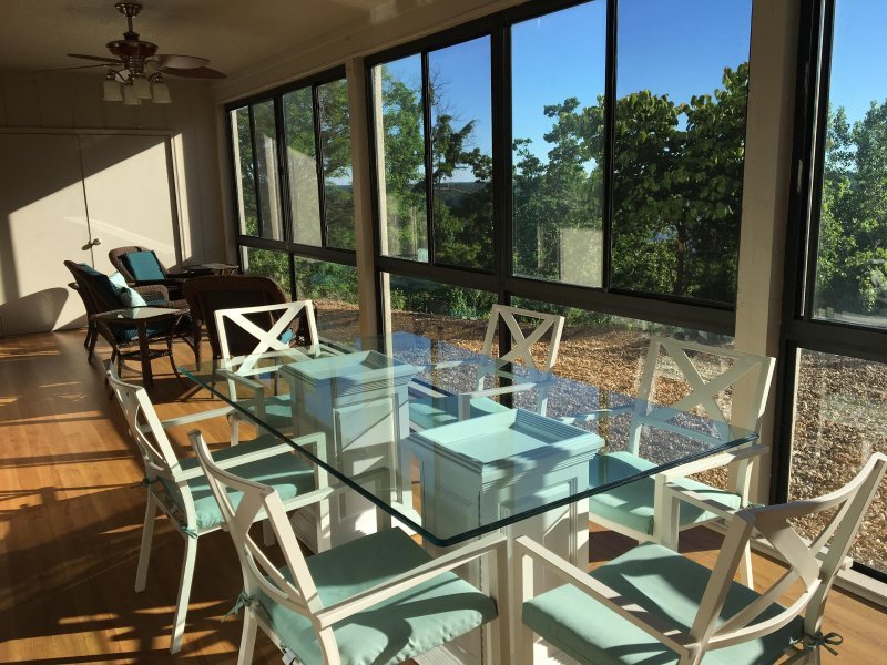 Dining table in the three-season room with a beautiful lake view!