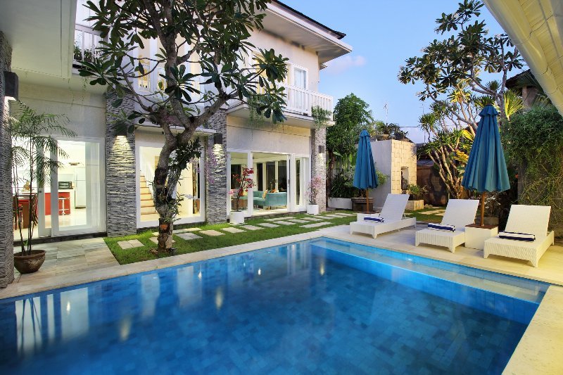 The pool & pool deck with lounge room, kitchen/dining room and upstairs bedrooms in the back ground