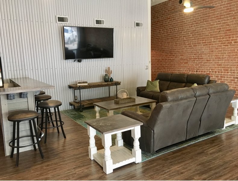 Shared living area with wet bar and 70' TV