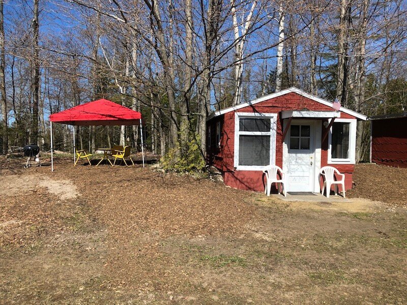 Rustic Camping Cabin with Cabana, Table & Weber Grille. 