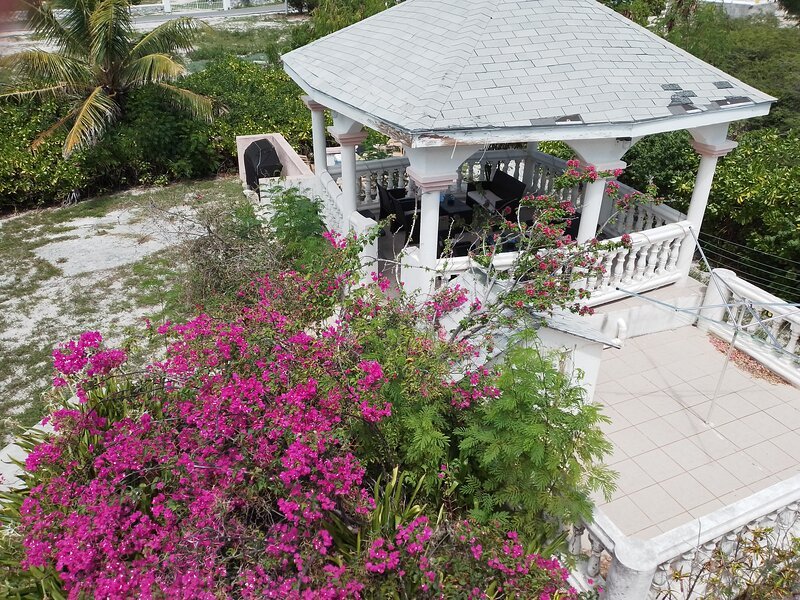 Lovely aerial view of the gazebo under which there is comfortable seating.